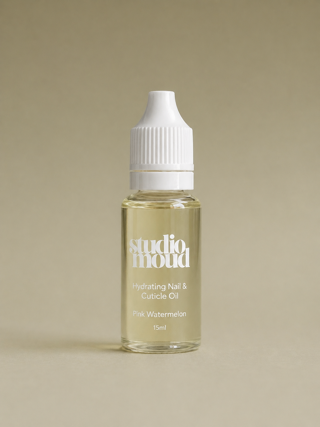 Bottle of studio moud nail and cuticle oil on a beige background